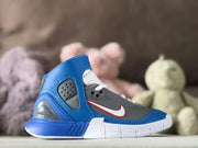 Side view of a blue, gray, and white kids' high-top sneaker with a contrasting side swoosh.