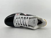 Top view of the shoe with white laces, padded collar, and Kobe logo on the tongue