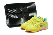 Yellow basketball shoes displayed beside a black-and-white shoe box.