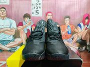 Front view of the paired basketball sneakers, showing the textured toe boxes, black laces, tongue logos, and treaded outsoles.