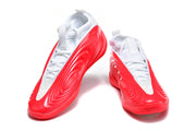 Pair of white and red sculpted sneakers shown from the front at an angle.