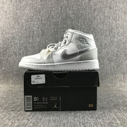 White and silver high-top sneaker displayed on its box; the box label shows youth model and size information.