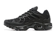 Side profile of a black Nike Air Max Plus TN-style sneaker with visible cushioning windows in the sole.