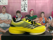 Side view of yellow and black low-top basketball shoes with black laces