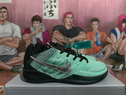 Side view of a mint green and black Nike basketball sneaker with a silver Swoosh.