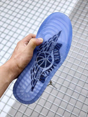 Bottom view showing the translucent blue outsole and circular traction pattern.