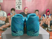 Rear view of blue Nike basketball sneakers showing the heel details and textured soles.