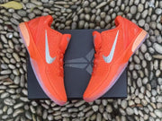 Overhead view of the orange pair positioned on a black box.
