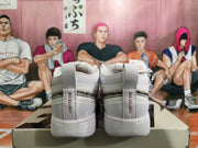 Rear view of white Nike sneakers with perforated panels and Chapter One heel straps