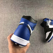 Rear view of the sneaker showing the blue heel panel, black collar, white midsole, and blue outsole edge.