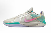 Light Nike low-top basketball sneaker with pink and teal accents, lavender outsole details and a sculpted sole.