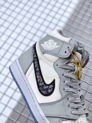 Side close-up showing the patterned Swoosh, Air Jordan wing detail, and gold charm.