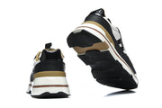 Rear and outsole views of black and white low-top sneakers with tan accents.