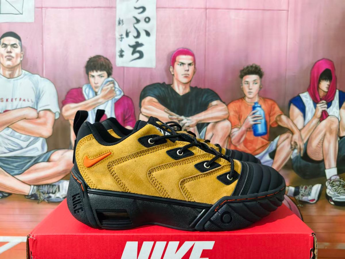 Side view of yellow and black Nike NDESTRUKT sneakers with orange accents