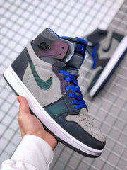 Front three-quarter view showing the gray perforated toe box, dark overlays, blue laces and iridescent side panels.