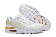 White Nike Air Max sneaker beside an outsole view showing gold-colored details.
