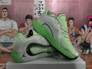 Angled view showing the layered side panels, black detailing, green midsole area, and Jumpman side branding.