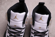 Close-up of the tongues and gold Jumpman details on a pair of Air Jordan 12 sneakers
