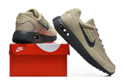 Tan and black Nike Air Max sneakers displayed with a red Nike shoe box.