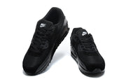 Pair of black Nike Air Max 90 sneakers viewed from above and the front.