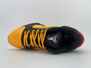 Top view of the shoe showing its orange perforated toe, black tongue, and yellow-orange laces.