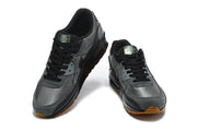 Pair of black and grey Nike Air Max 90 sneakers viewed from the front