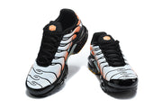 Front view of Nike Air Max Plus sneakers with black laces and white-to-orange panels