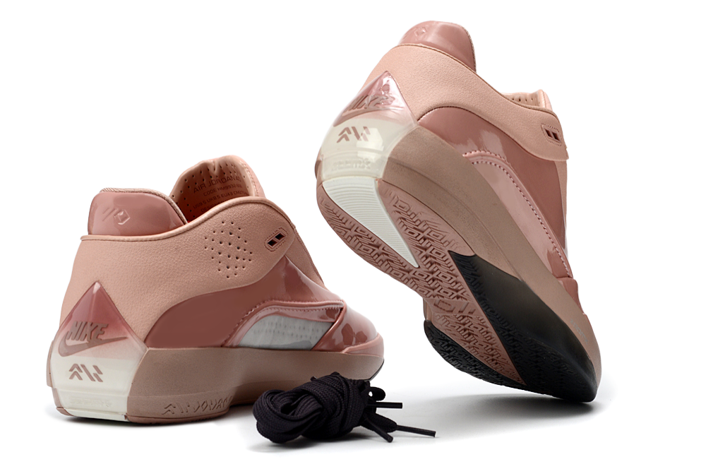 Rust pink Jordan 40 shoe pair viewed from the heel and outsole, with black laces shown beside them.