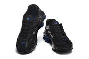 Top and front views of black Nike Shox R4 sneakers with blue accents.