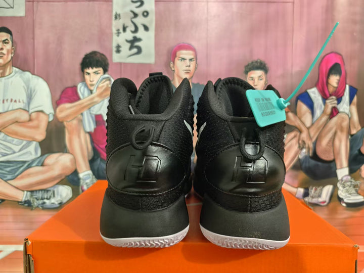 Rear view of black Nike Hyperdunk basketball shoes with white outsoles