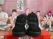 Front view of black Nike basketball sneakers with lace-up closures and padded tongues.