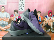 Pair of purple and black Nike basketball shoes showing the patterned heels and textured soles