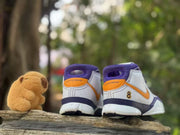 Rear view showing the heel panels, orange pull details, purple collars and number 8 marking.