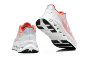 Rear and outsole views of white and coral On Cloudtilt Remx sneakers.