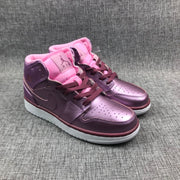Three-quarter front view of the pair showing pink collars, perforated toes, and burgundy laces.