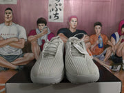 Front view of grey Nike sneakers showing the lace-up construction and vertically ridged toe box.