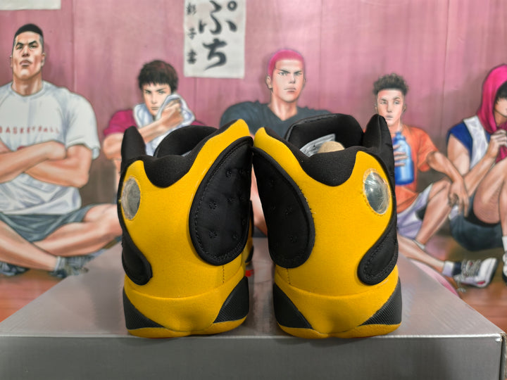 Rear view of black and yellow high-top basketball sneakers