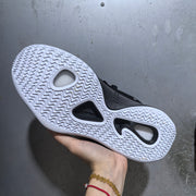 Close-up of the sneaker outsole showing a white repeating traction pattern and black cutout sections.
