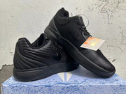Two black shoes displayed together, showing their side and upper details