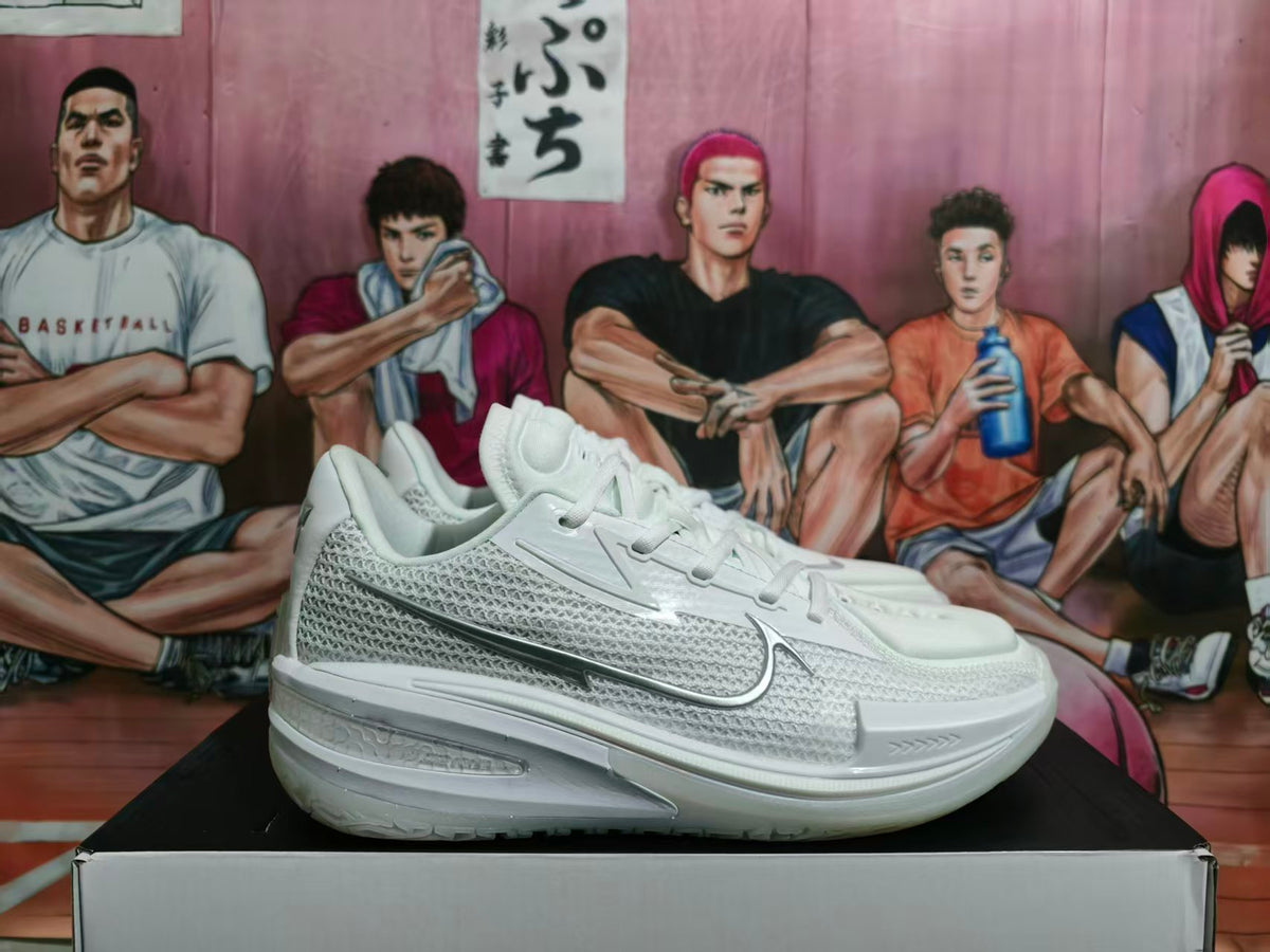 White Nike basketball sneakers shown from the side on a box.