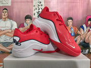 Pair of red and white basketball shoes shown from the side and above