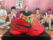 Side view of a red Nike basketball sneaker showing the black Swoosh, textured upper, green laces, and Zoom-marked sole.