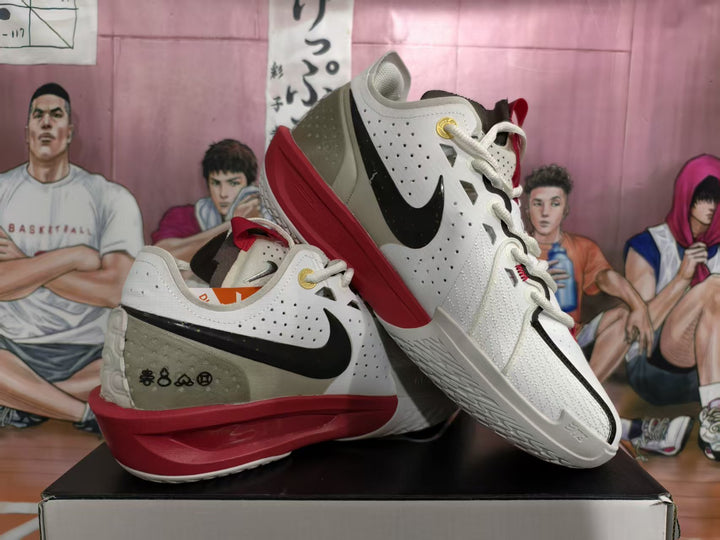 Pair of white, black, gray, and red Nike basketball sneakers displayed on a shoebox.