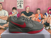 Side view of a grey Nike basketball sneaker with a red swoosh, layered upper panels and a red outsole.