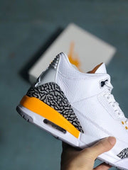 Side close-up showing the elephant-print overlay, orange midsole panel and visible heel air unit.