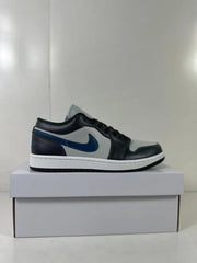 Side profile of the black, grey, and blue sneaker displayed on a white shoebox.