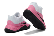 White and pink Nike basketball sneakers shown from the rear and outsole angles.