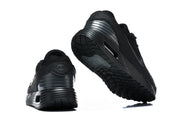 Black Nike Air Max sneakers shown from the rear and outsole.