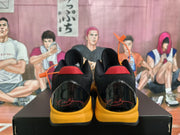 Rear view showing the black heel panels, red collar accents, yellow midsoles, and red heel graphics.
