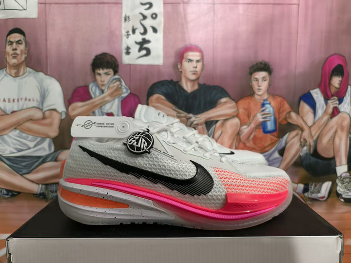 White Nike basketball shoes with black Swoosh accents and pink and orange details, shown from the side.